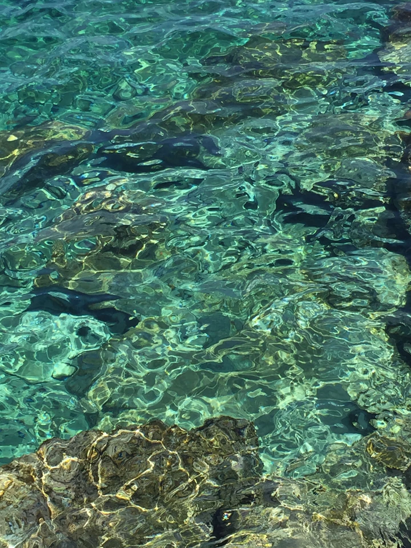 Sunlight moving across clear turquoise water